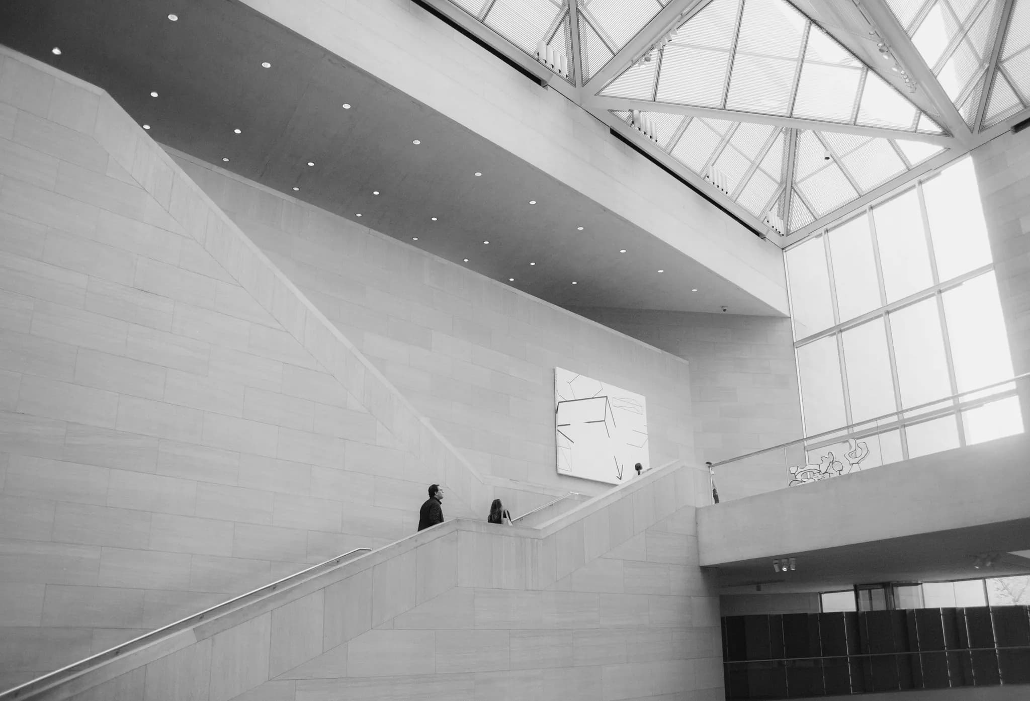 Atrium with a folded stone stair under a glass roof